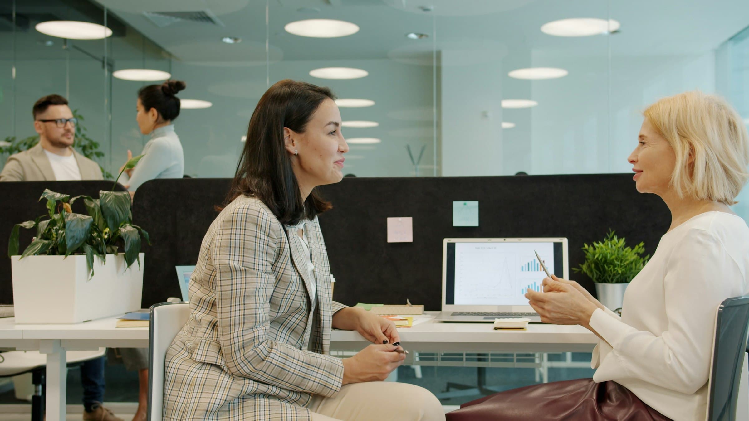 Two billing professionals collaborating at a desk